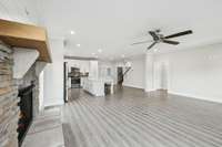 The open living room is filled with natural light, anchored by a cozy fireplace and designed for both gatherings and quiet evenings at home.