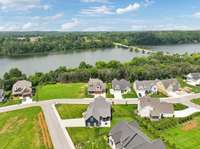 See the full picture: aerials showcase the home’s generous lot, corner placement, and its connection to the neighborhood and lake.