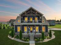 Welcome to 120 Pontoon Place! This corner lot craftsman stuns with curb appeal, double front porches, and lake views. Imagine sunsets from the upper porch and easy mornings on the lower.