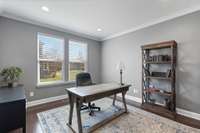 There's plenty of room in the office for a large desk, bookshelves, etc. This room features crown molding, hardwood flooring, and recessed lighting.
