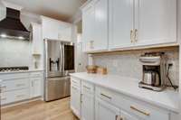 Beautiful backsplash tile that runs from the counter tops to the ceiling.