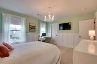 The walk in closet has a closet system.