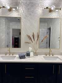 Primary bath with new quartz countertops, new fixtures, new hardware, new cabinets, new mirrors, new LED lighting, and double sinks