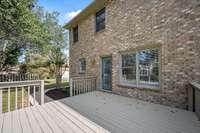 The freshly stained deck overlooks the lovely, tree-shaded yard.
