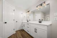 The Primary bath features this new double vanity with quartz counters and private lavatory room with new water closet.