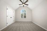 The front bedroom features this vaulted ceiling and arched window.