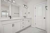 Primary Bathroom with tile floors and quartz countertops