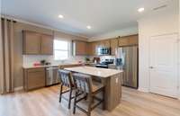 ***Photo is from a brand new Rosella Model home*** The Kitchen is the heart of the home, and this one will not disappoint. We have included gray cabinetry, white quartz countertops, and a white subway tile backsplash.