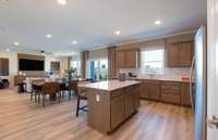 ***Photo is from a brand new Rosella Model home*** The island provides additional storage space while also being the perfect location for quick meals.