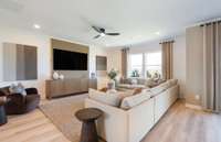 ***Photo is from a brand new Rosella Model home*** The spacious Great Room is perfect for movie nights and relaxing with friends.