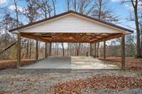 Huge 24x30 carport with concrete pad that can easily be enclosed to make a garage.