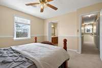 The primary bedroom also features an en-suite full bathroom with double vanities, a walk-in closet, and a lake view.