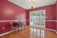 Dining room is generously sized for a large table. The French doors lead to the sunroom, and to the right is the kitchen.