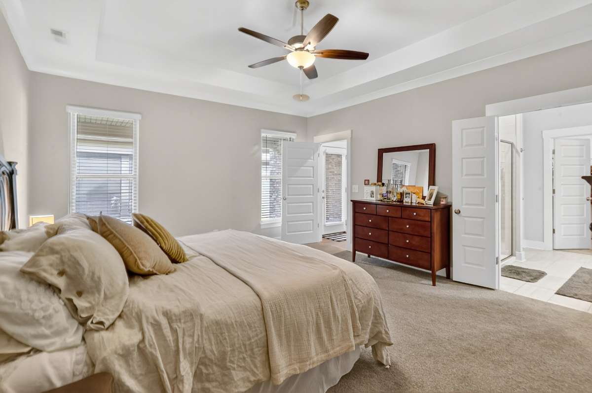 The Primary located to rear of the home offers privacy, while the bathroom provides an oversized tile shower, double vanities as well as a walk in Closet.
