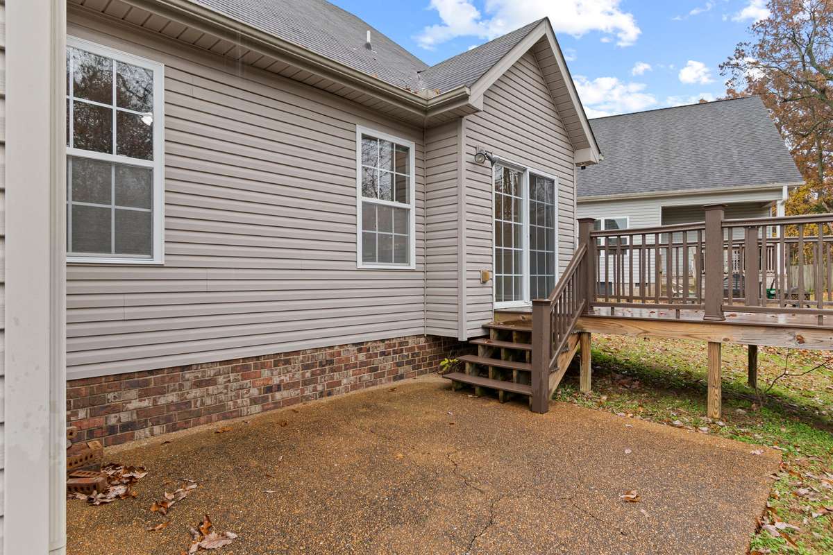 Back yard: offering Trex decking and patio with enhanced privacy as it backs up to a neighboring property situated on several acres