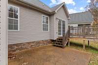 Back yard: offering Trex decking and patio with enhanced privacy as it backs up to a neighboring property situated on several acres