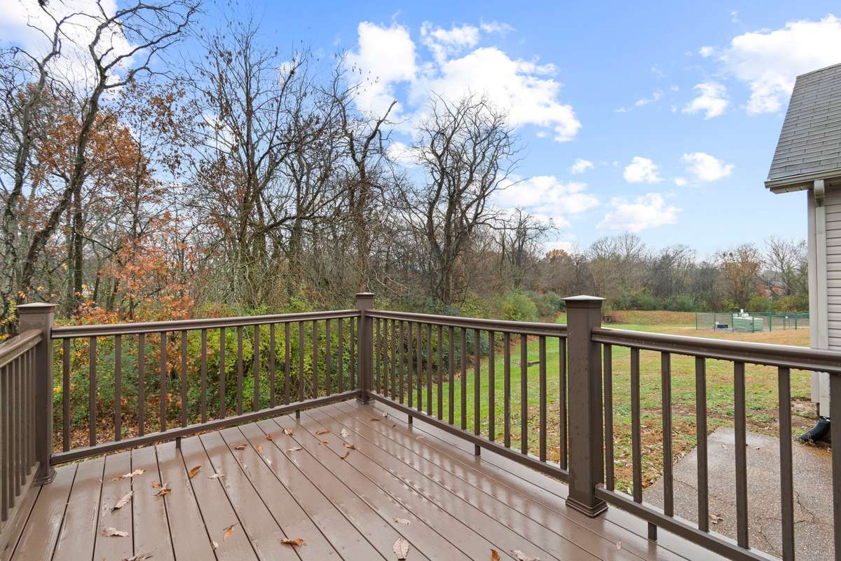 Back yard: offering Trex decking and patio with enhanced privacy as it backs up to a neighboring property situated on several acres