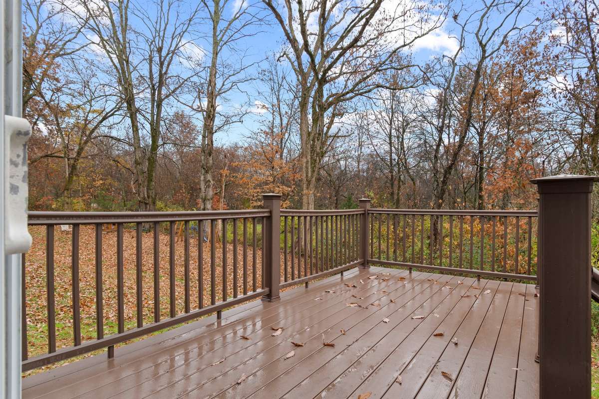 Back yard: offering Trex decking and patio with enhanced privacy as it backs up to a neighboring property situated on several acres