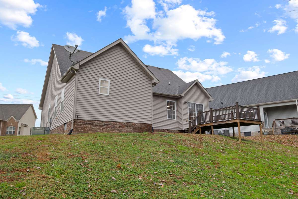 Back yard: offering Trex decking and patio with enhanced privacy as it backs up to a neighboring property situated on several acres