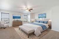 Virtually staged Primary suite is super spacious and has a massive walk in closet!