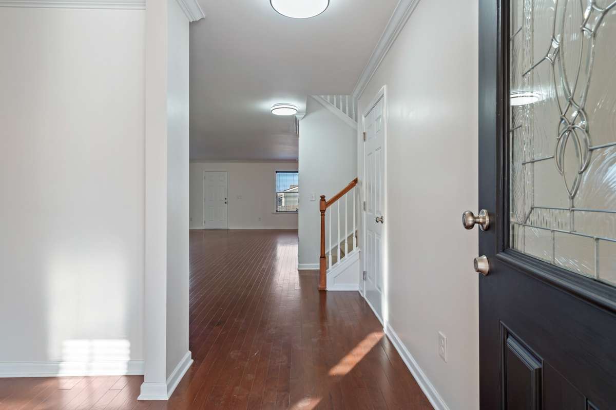 Entry foyer with traditional dining room to the left. Beautiful hardwood floors on main level.