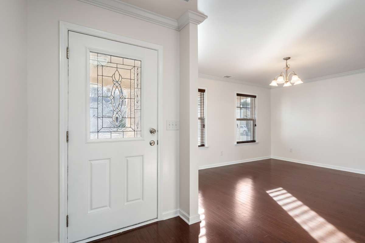 View from foyer to front door and dining room.
