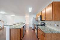 Stainless, granite and hardwood!  New, updated faucet coming soon.