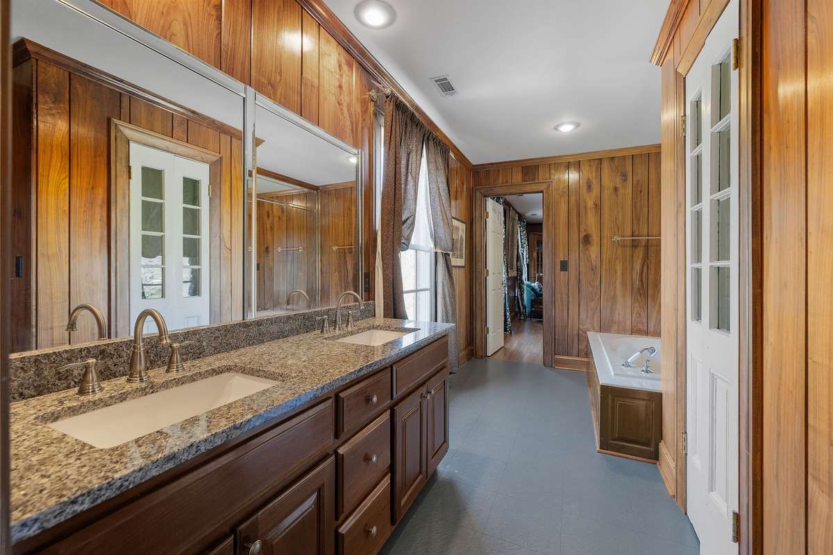Bathroom off of Bedroom and Den. Solid walnut paneling.
