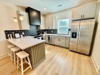 All stainless Whirlpool appliances with closet pantry