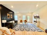 View of the living room on the 2nd floor with direct access to the balcony. Lots of windows!