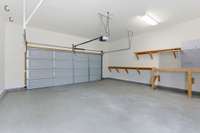 Two-car garage from courtyard door. Features epoxy coated floor.
