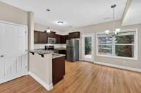 Functional kitchen with ample counter space and plenty of sunlight from back patio.