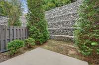 With the combination of the stoned wall, mature trees and privacy fencing on both sides, you have your own private oasis.