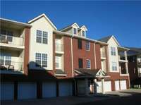 This is the rear side of building A with access to your dedicated garage space.  There is room for a second car on the parking pad.