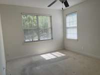 The primary bedroom is flooded with natural light.  New carpet has been installed since this photo was taken.