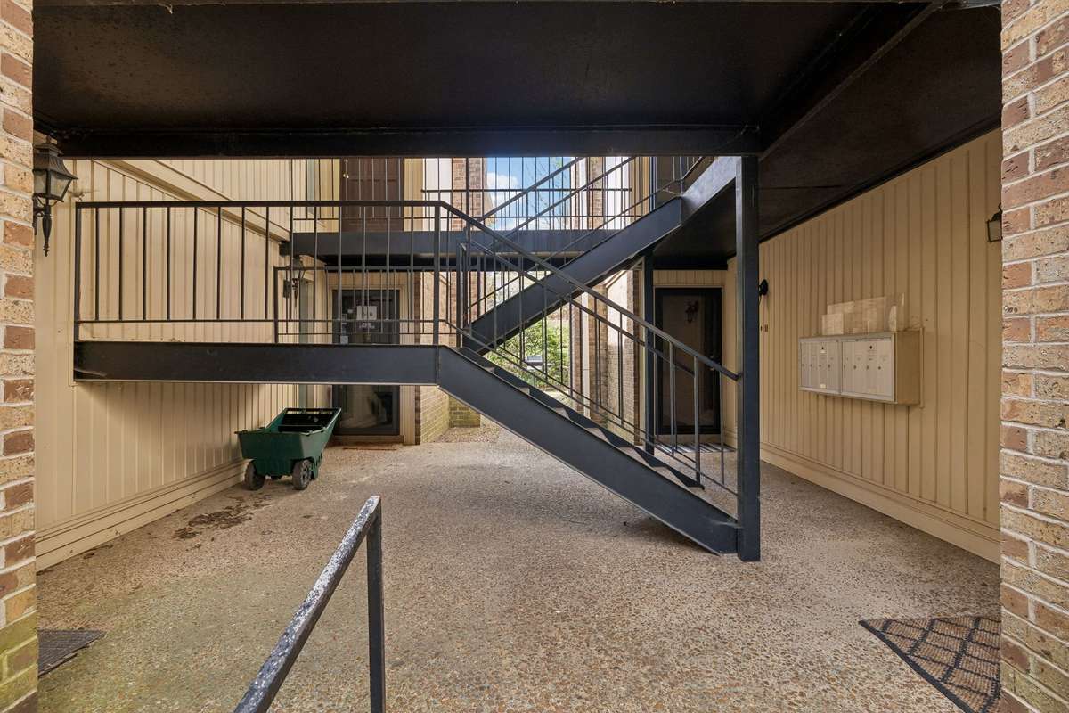 A closer look at the staircase. This unit is on the first level with the door to the back right side. Notice the bank of mail boxes is on the wall to the right.