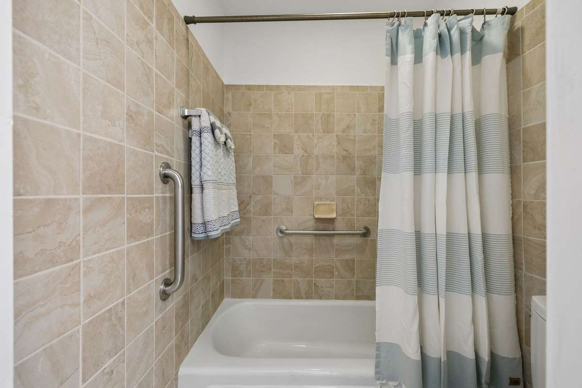 The second portion of the Full Bath has tile on the walls, on the combination tub/shower, and on the floor!