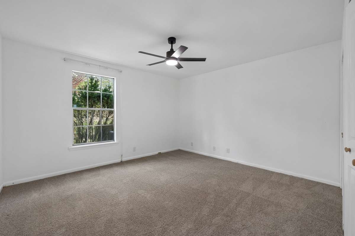 The Bedroom with window to the rear of the unit and new Ceiling Fan/Light.