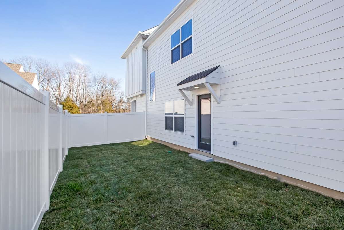 Picture is of the Madison Americana built on another lot.  Lot sizes vary but they all come standard with  privacy fences and full sod and irrigation. Builder to added a 10x10 concrete patio to lot 16! you will have room to grill and chill!