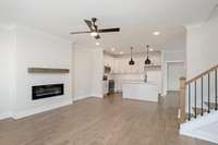 Picture is of the Madison Americana built on another lot. View of the open floor plan where your kitchen and greenroom are open. Great spaces to add some built ins on the side of your fireplace.