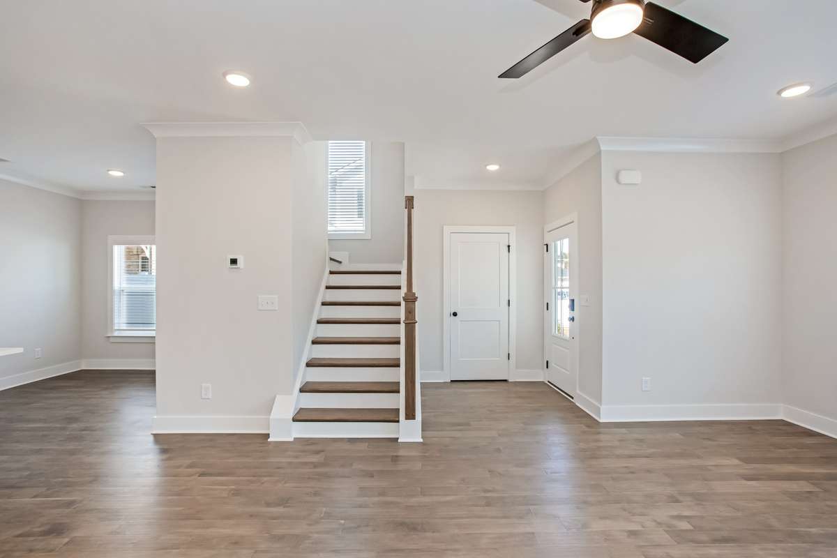 Picture is of the Madison Americana built on another lot. This view shows the foyer when you come in through the front door, coat closet to your tight and a perfect spot for your table. and lamp! To the left of the stairs is your dining room,