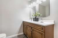 The en-suite primary bathroom features a spacious double-sink vanity with rich wood cabinetry offering plenty of storage and a warm, classic look.