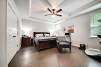 Large primary suite with wood floors on main floor.