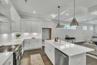 This open-concept kitchen showcases Frigidaire Gallery® stainless steel appliances, sleek quartz countertops, and custom maple cabinetry - combining style, function, and modern elegance.