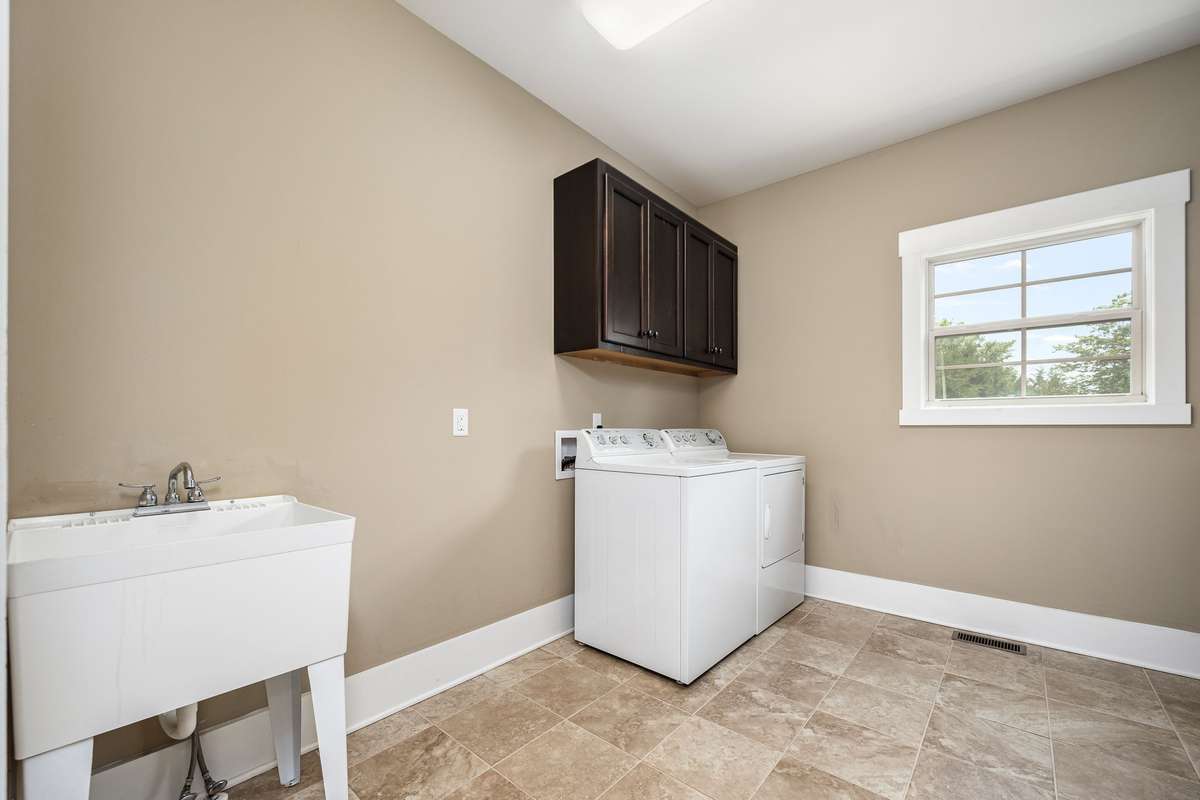 And there's a wash sink and tile floors.