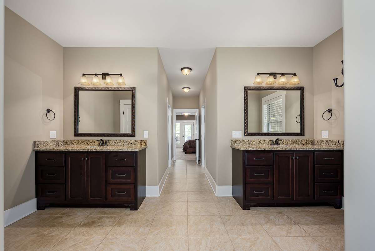 The primary bath suite is well appointed with his & her separate vanities, tile flooring as well as his & her walk-in closets.