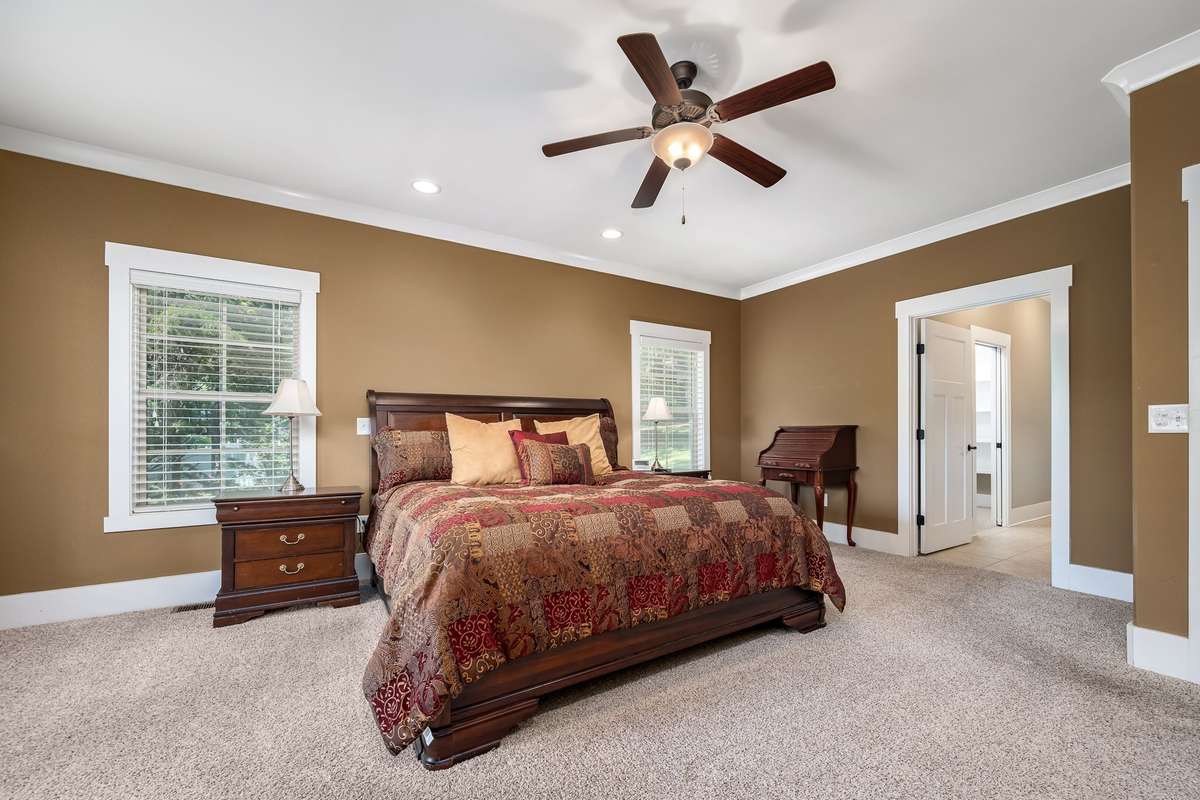 His & her reading lights, ceiling fan, crown molding and tons of natural light.