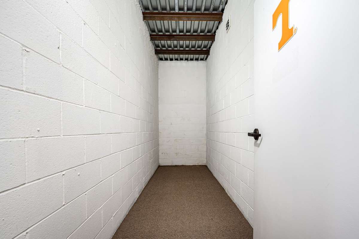 Storm shelter in basement - 14x5, solid core concrete walls, steel & concrete ceiling with steel door, 8 ft underground.