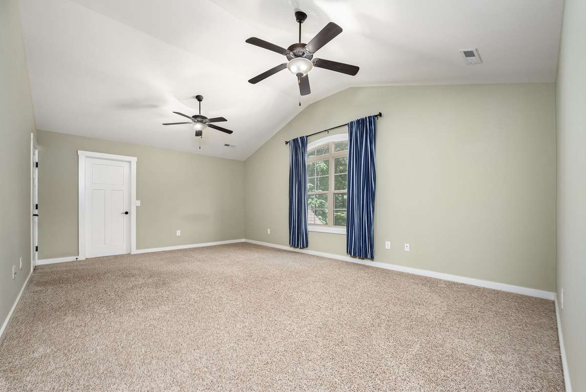 Bedroom 3 upstairs is 21x14 in size and has a large 11x10 closet. Double window overlooking the front yard, double ceiling fans and vaulted ceiling.