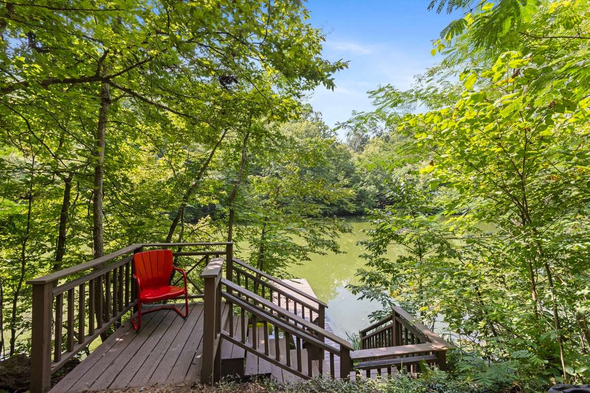 Surrounded by lush woods, the lake features multiple community docks, perfect for launching a kayak or canoe. This dock has been recently upgraded with new deck boards and is freshly stained. This dock is directly in front of the Bradford cabin.